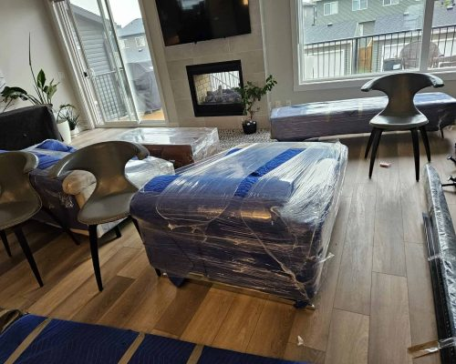 Furniture protected with moving blankets inside a home