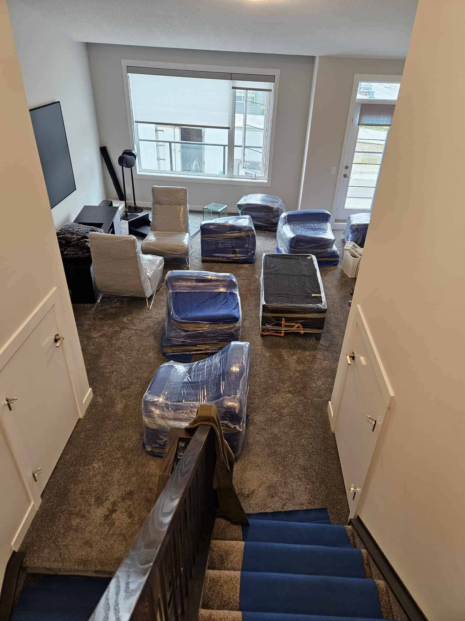 Moving boxes and furniture packed in a modern apartment for a professional move in Calgary.