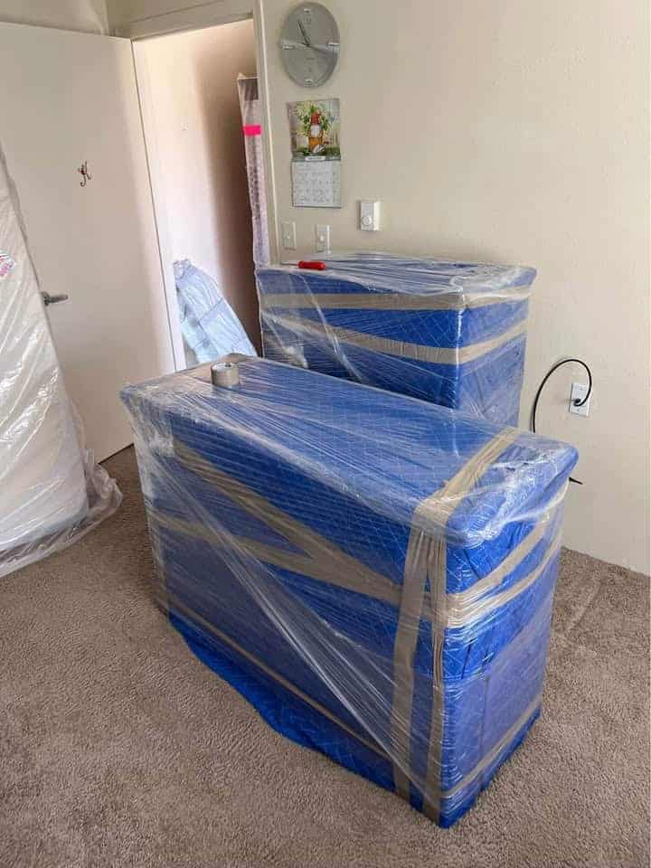 Wrapped furniture and moving boxes in a home for safe transport in Calgary.