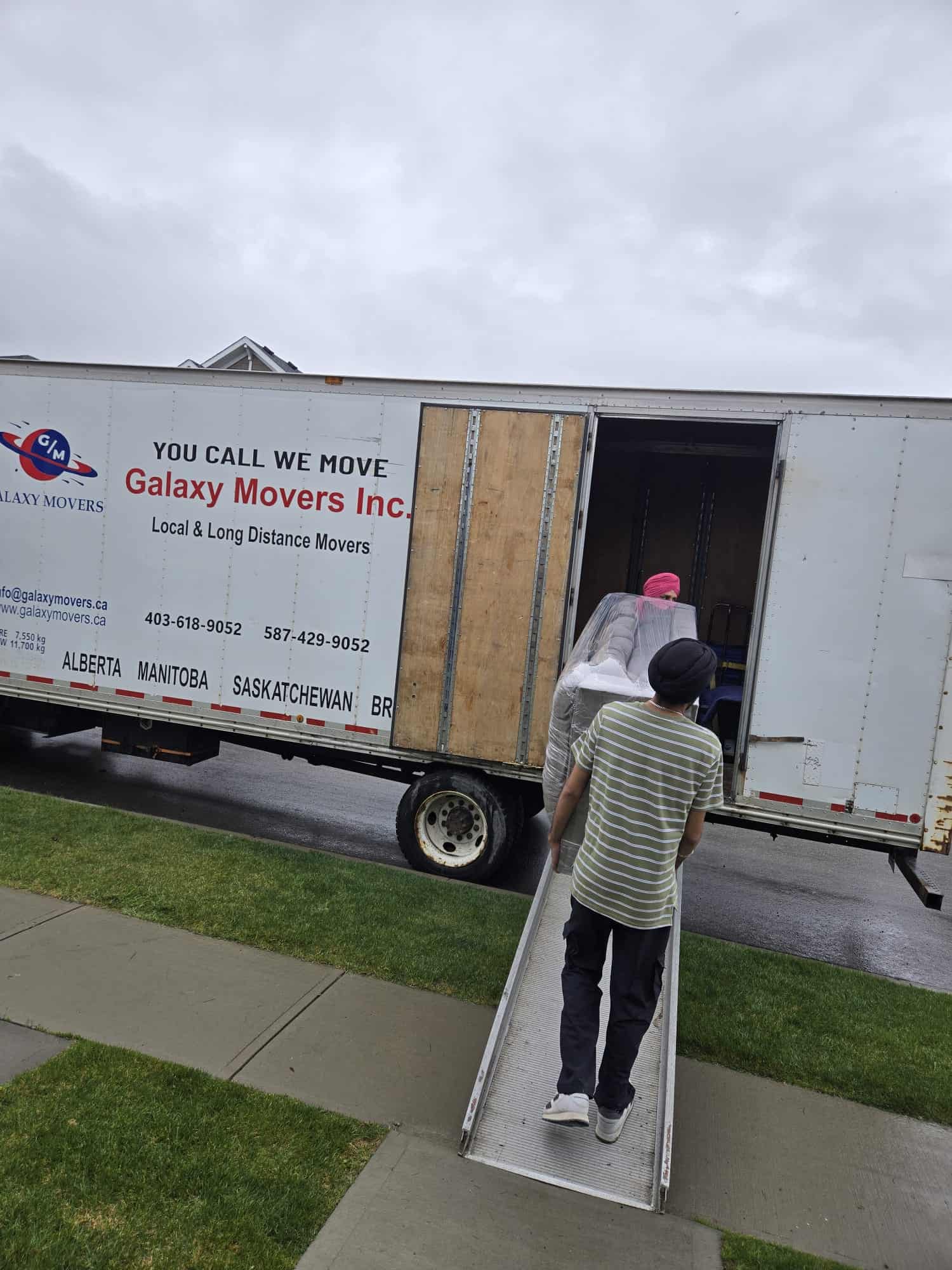Team of Galaxy Movers loading into a truck