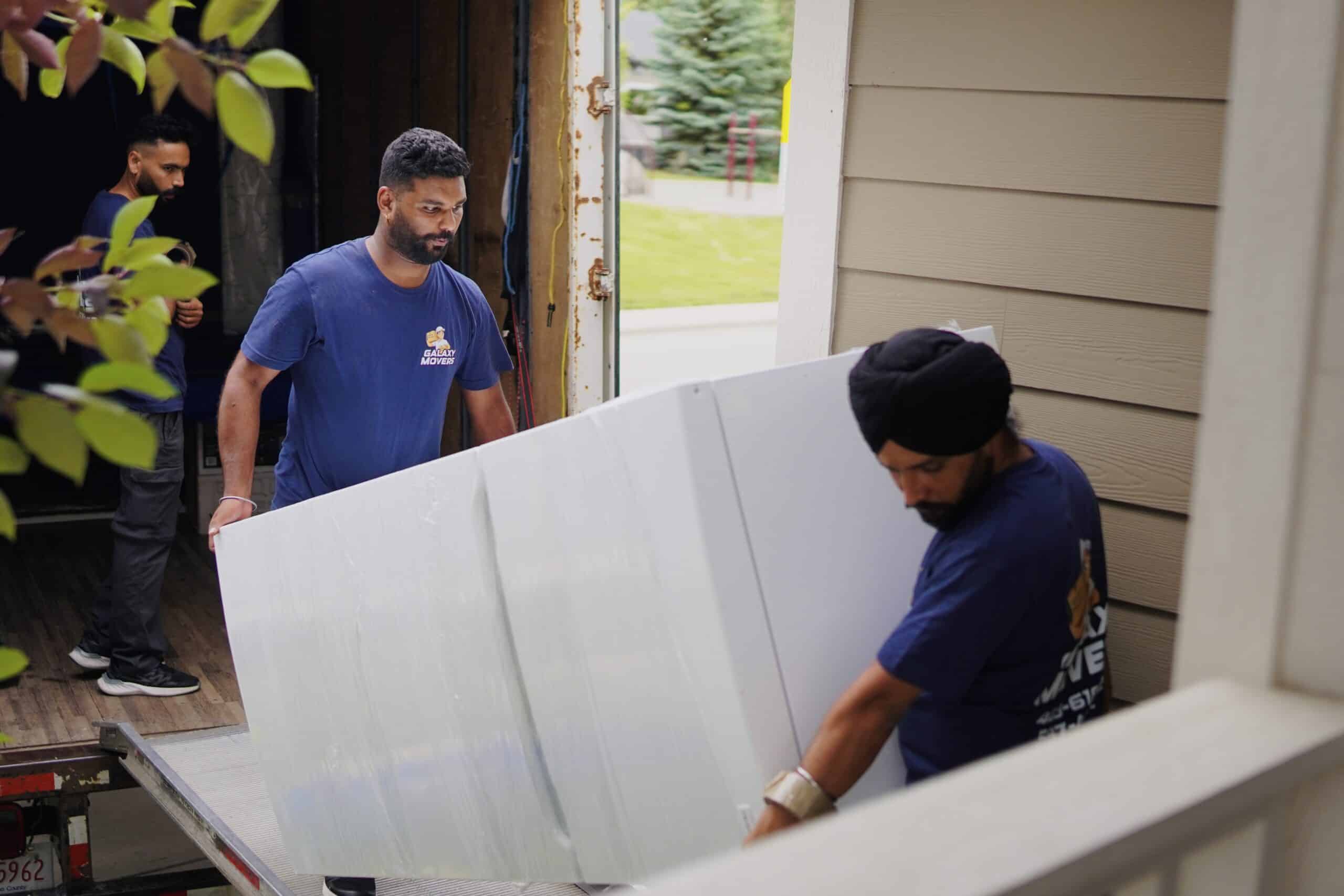 Movers in Beaumont loading furniture into a truck