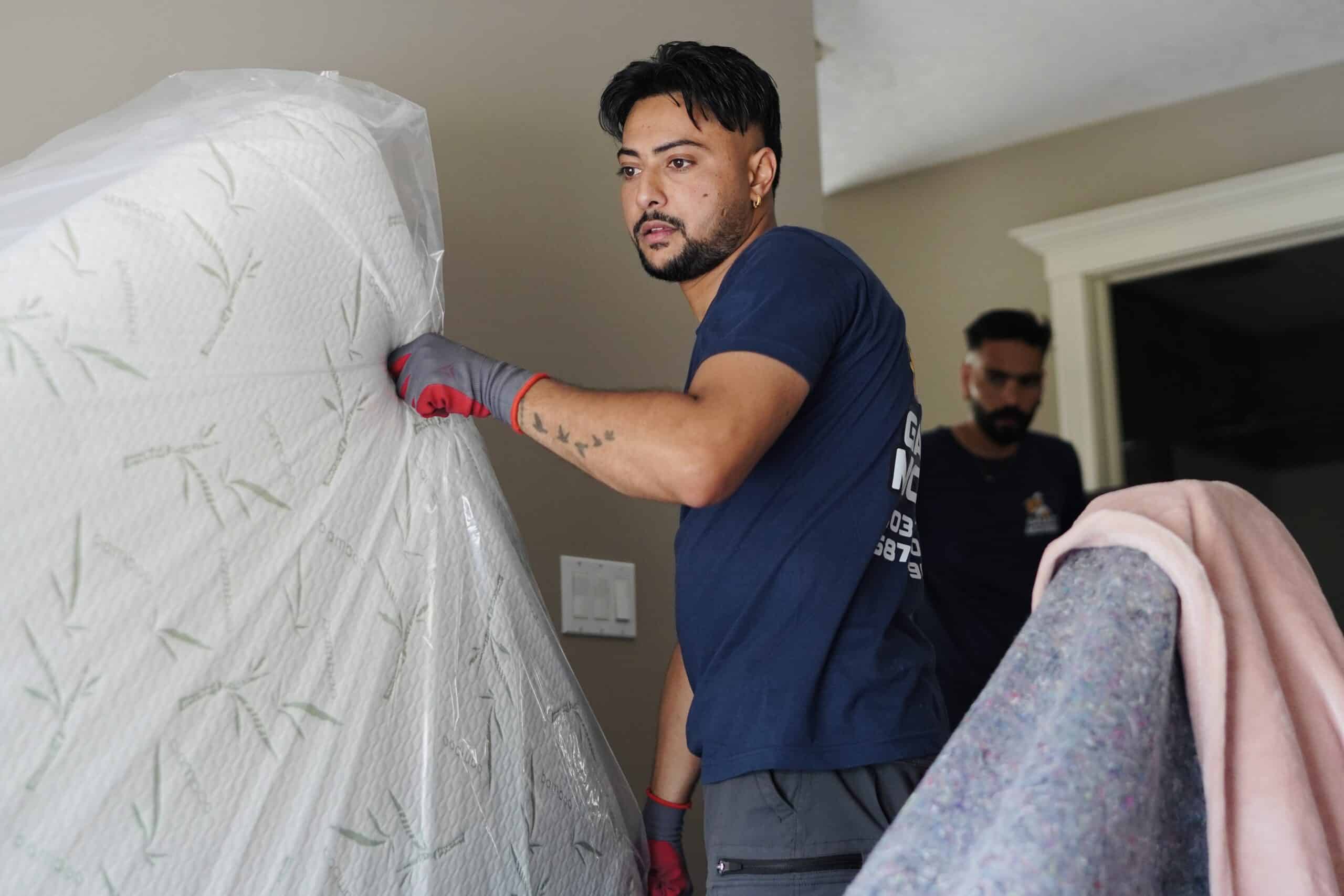 Mover wrapping furniture during a Bonnyville move