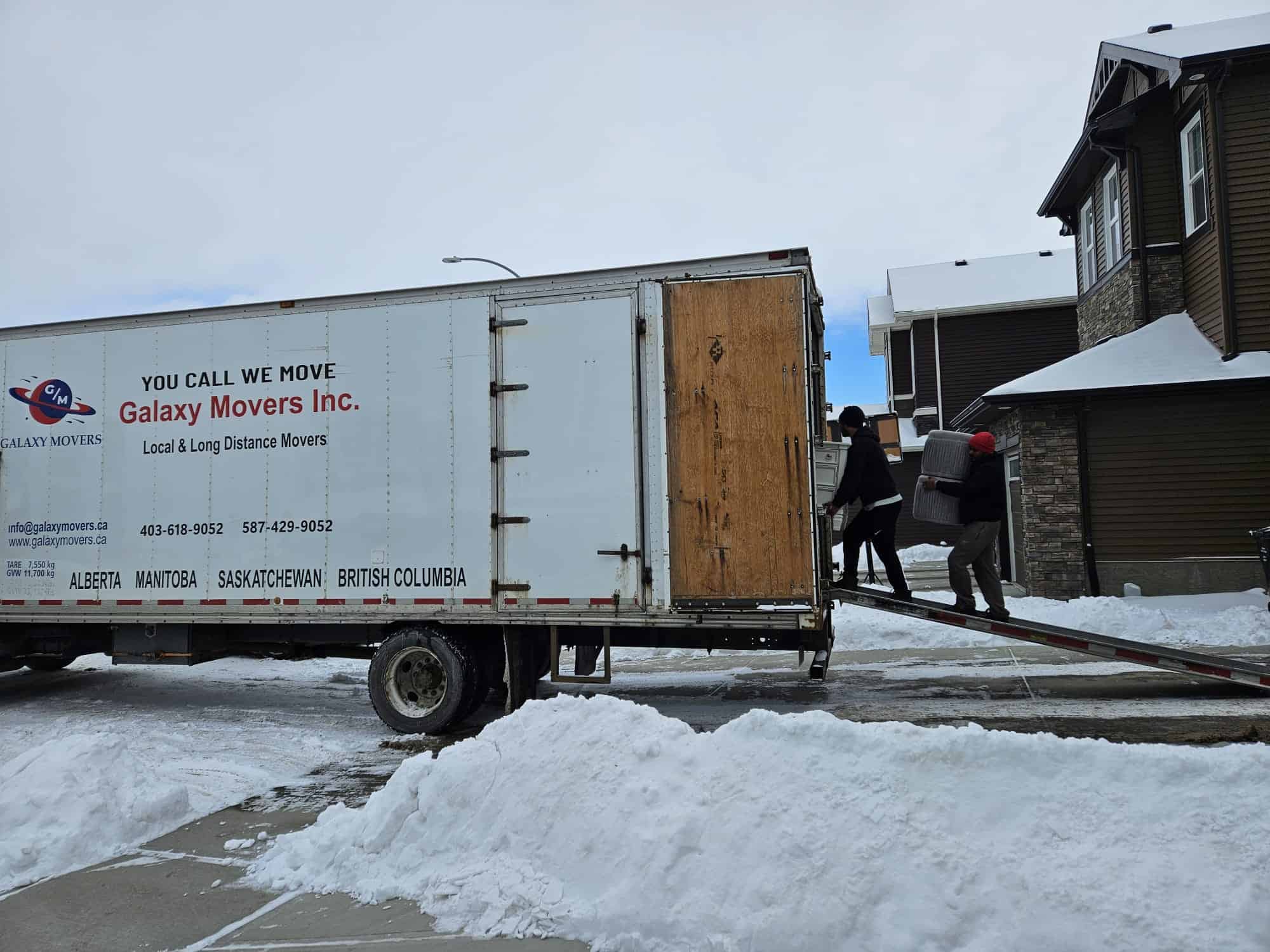 Moving truck with crew loading furniture in Cardston
