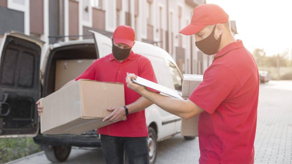 Movers in Carstairs AB loading boxes into a van