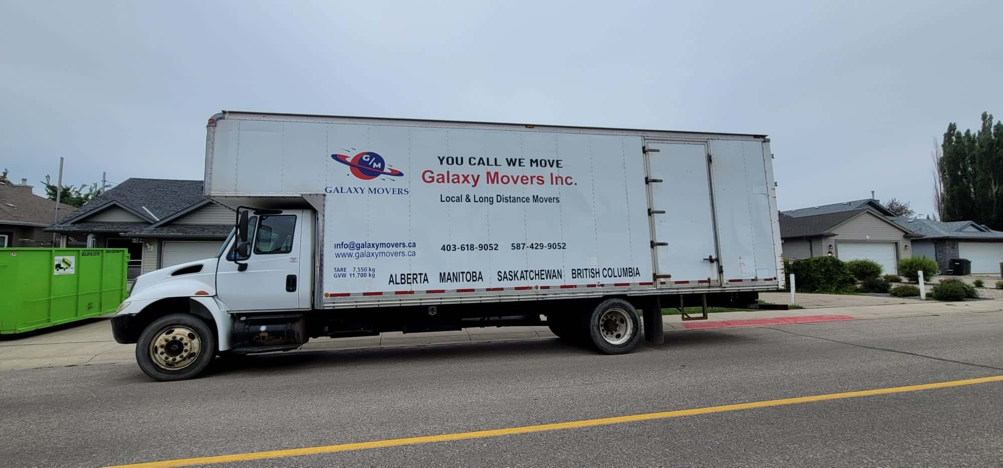 Moving truck with Galaxy Movers branding in Calgary neighborhood