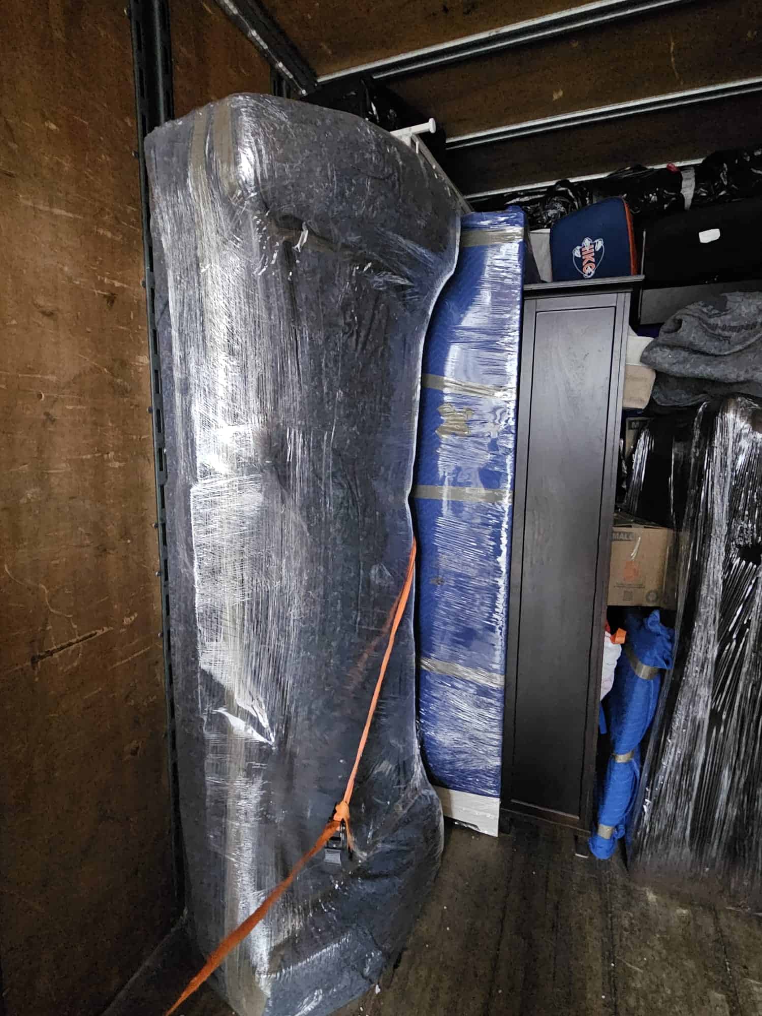 House movers handling wrapped furniture in Cochrane