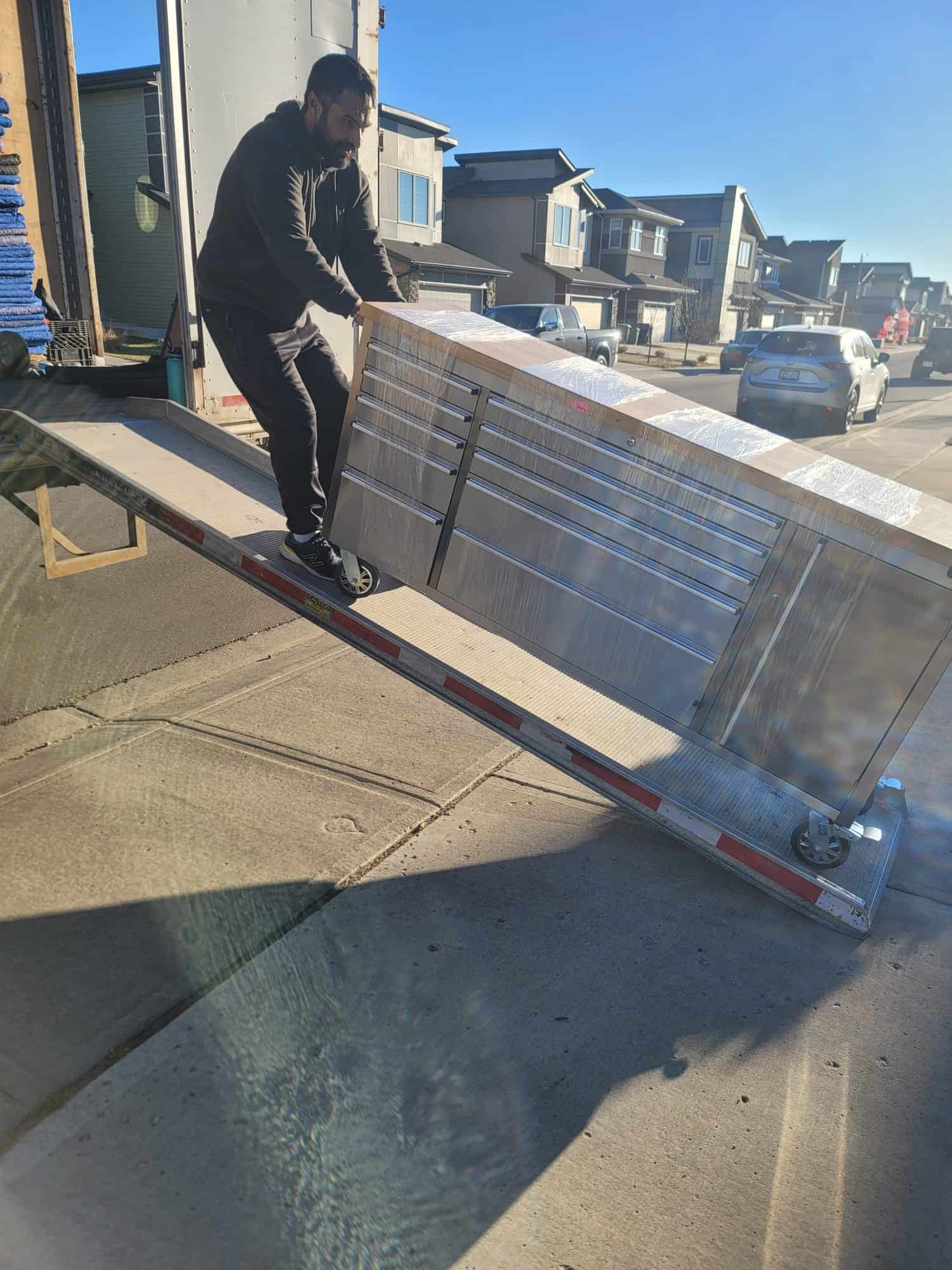 Professional movers handling equipment in Cochrane