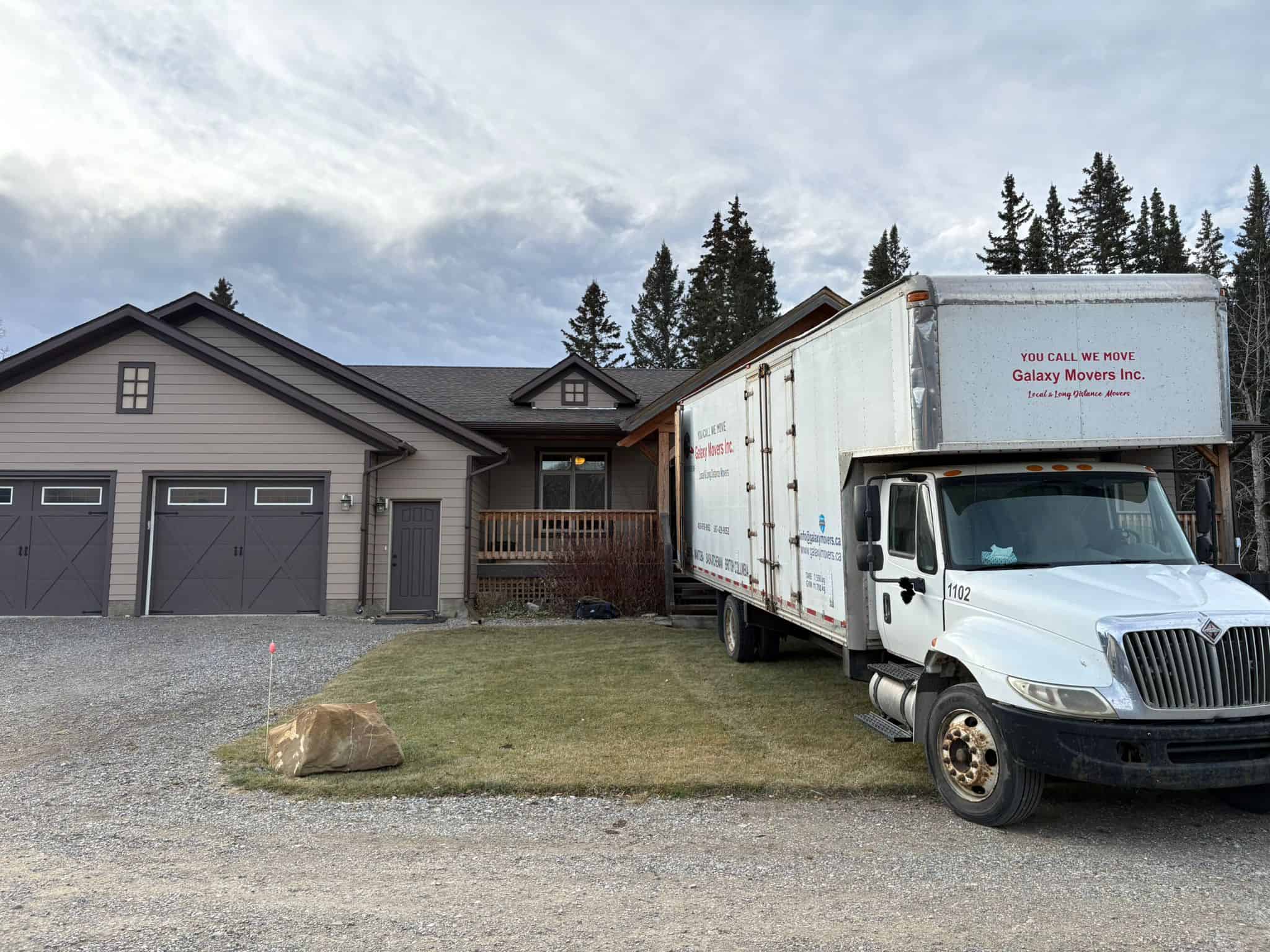 Moving truck from Galaxy Movers in front of a house in Calgary.