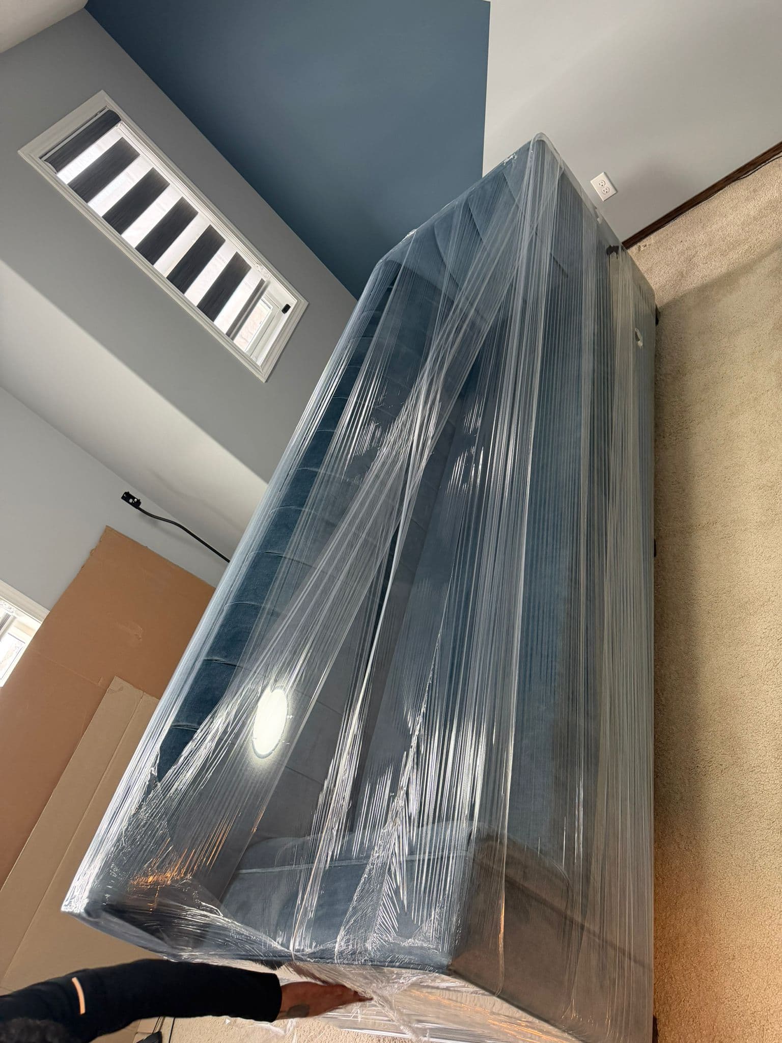 Large new refrigerator wrapped in plastic for delivery in Calgary.