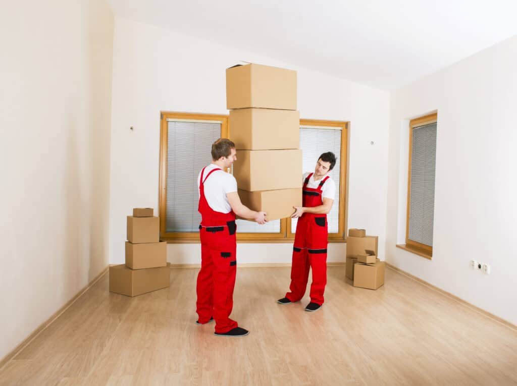 Movers in Lethbridge AB packing and organizing boxes in a new home.