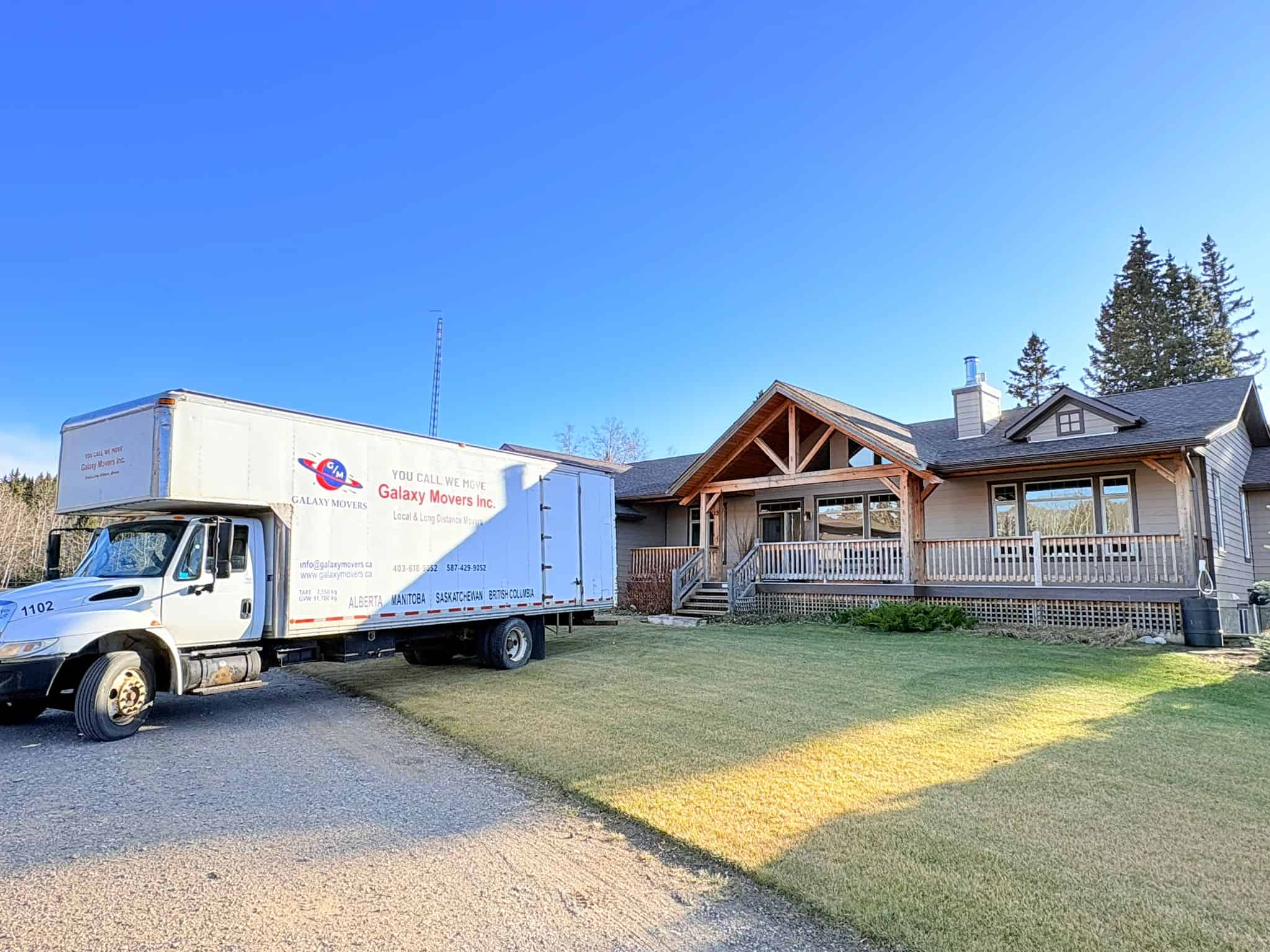 Moving truck from Galaxy Movers parked in front of a house in Calgary.
