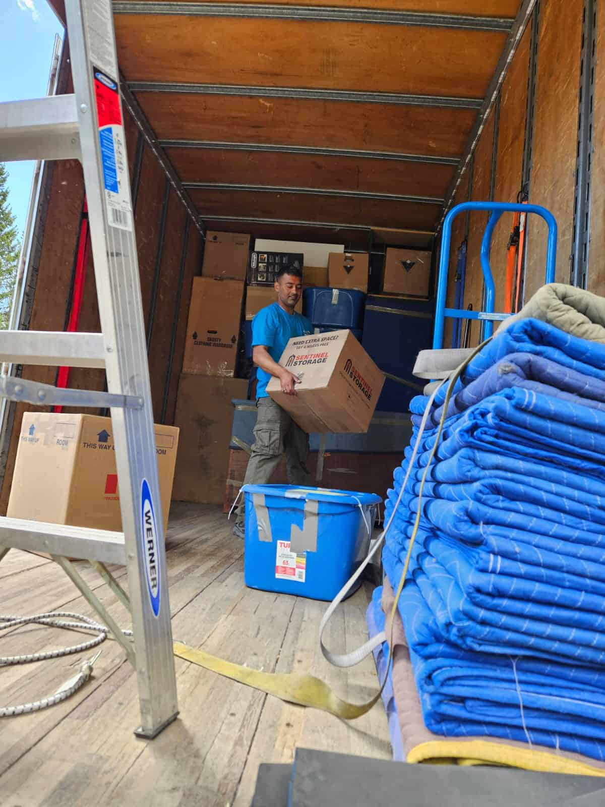 Mover loading boxes into a moving truck in Spruce Grove