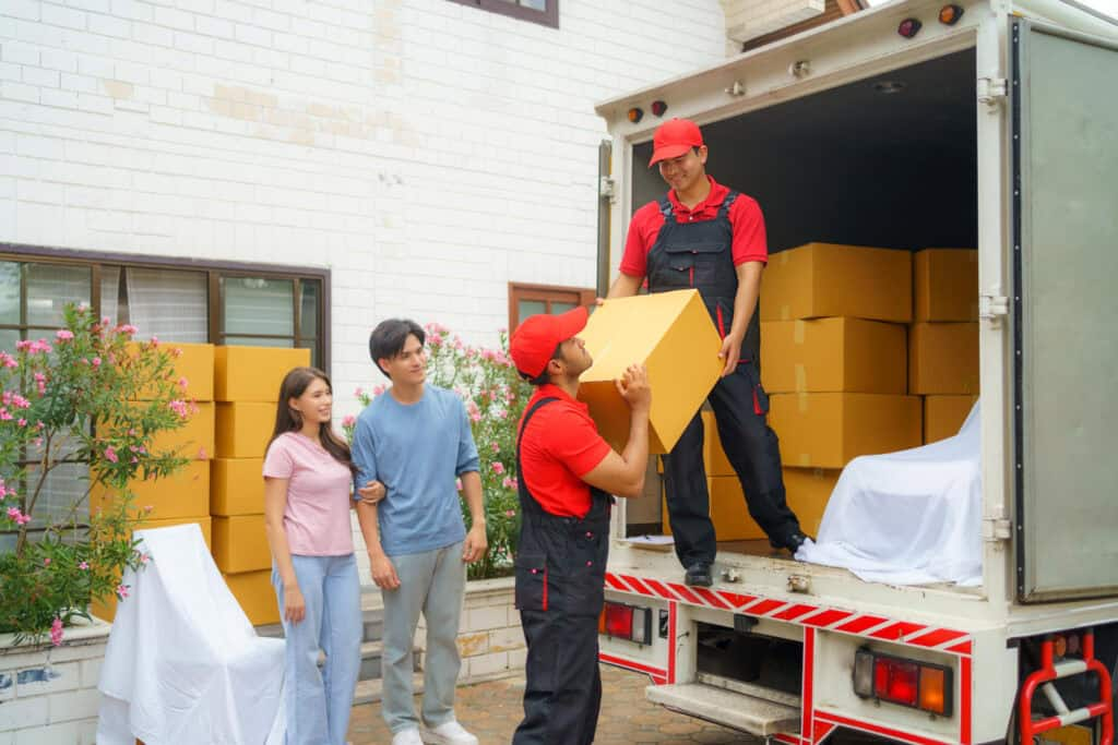 Movers loading boxes into a truck with customers watching in Calgary.