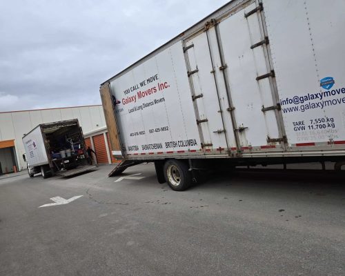Moving trucks parked outside a warehouse for professional Calgary moving services.