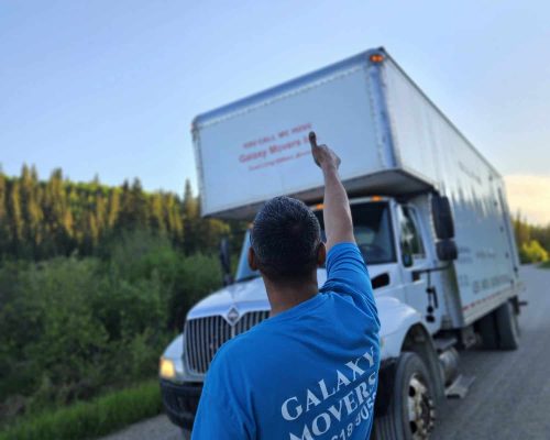 Moving company professional guiding a moving truck in Calgary, Alberta.