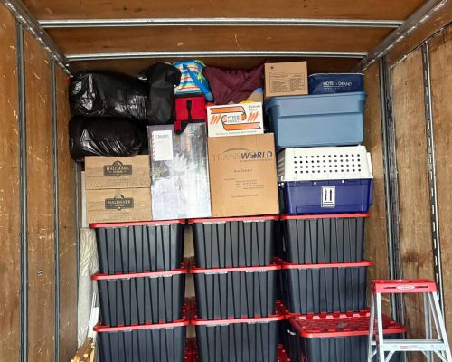 Efficient moving truck packed with boxes and storage bins in Calgary.